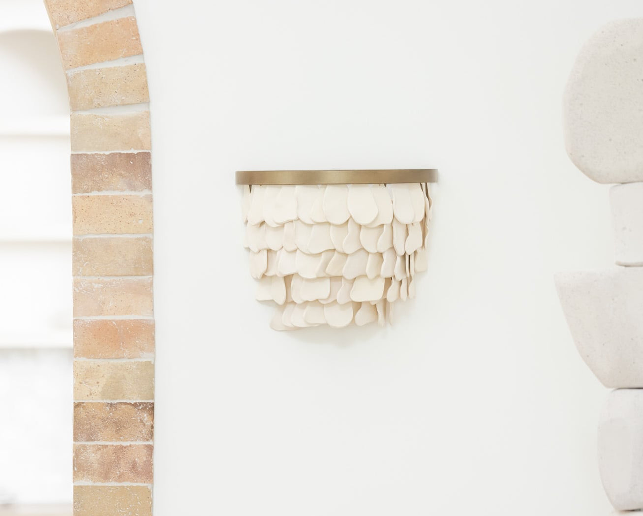Decorative wall art with ceramic elements in a neutral color palette.